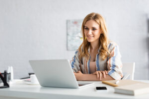 female at a desk looking at a computer having set up her business
